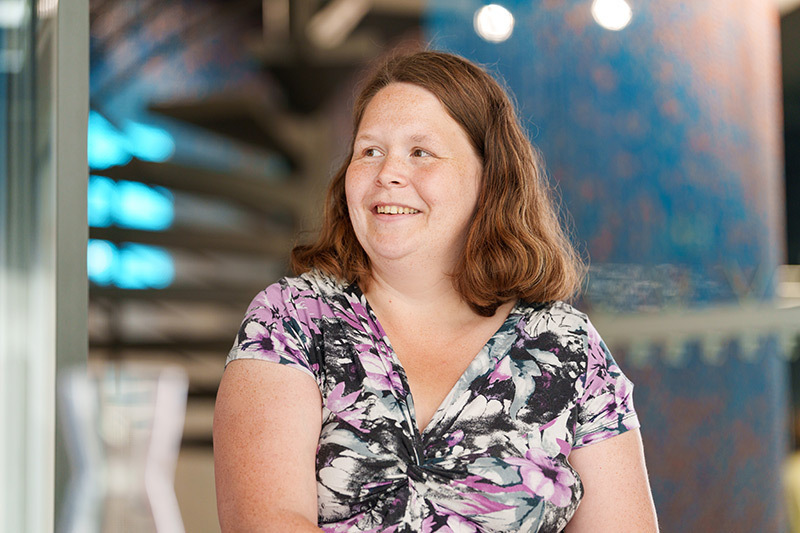 Lena Oden sitting at a table and smiling