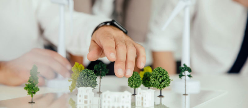 Urban planners moving around items on a model of a town district