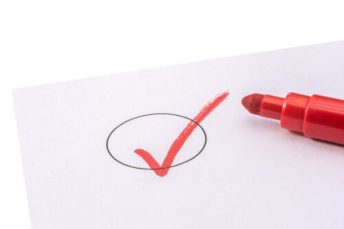 A checklist marked with a red pen