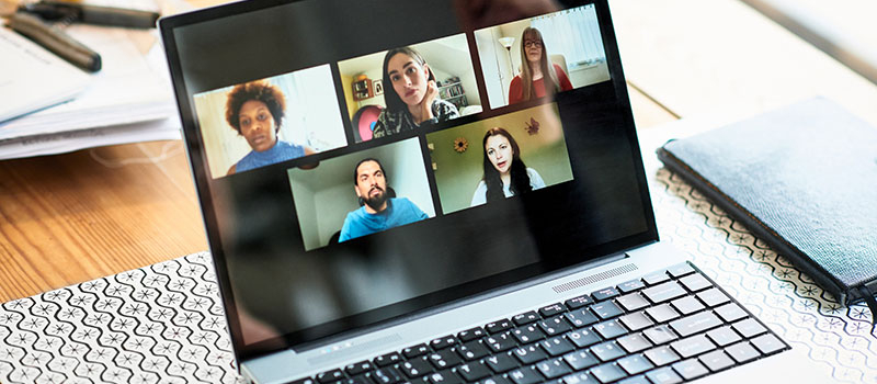 Laptop screen showing participants in a video conference