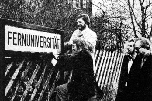 Ralf Bartz and Rolf von der Heyden attach a sign reading