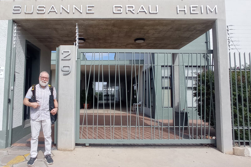 Mann steht vor einem Gebäude