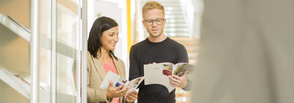 Two people look at informational brochures together