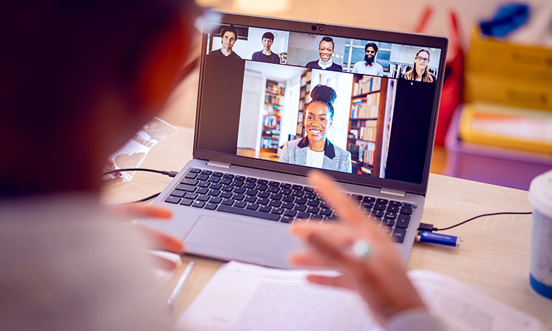 A laptop screen showing people having a video meeting