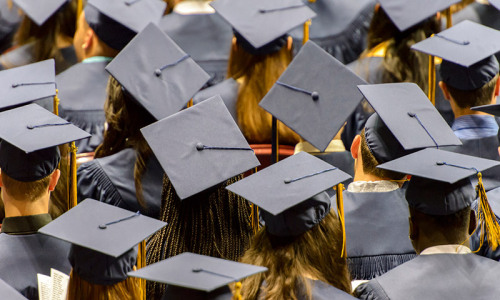 Group of people wearing mortarboard hats
