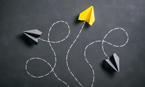 Chalkboard and paper planes with twisted trails
