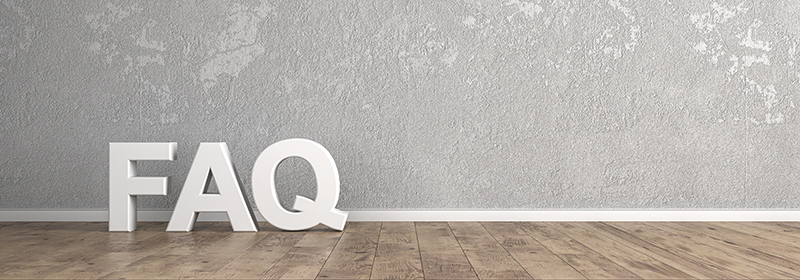 The letters F, A and Q sitting on a wooden floor
